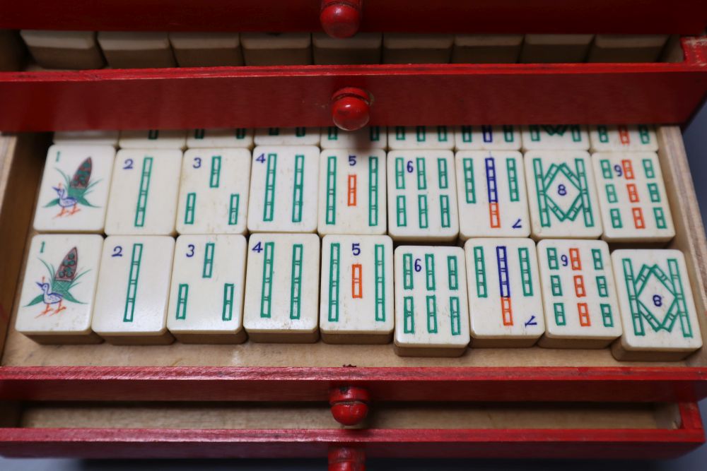 A Mah Jong set in red stained wood case